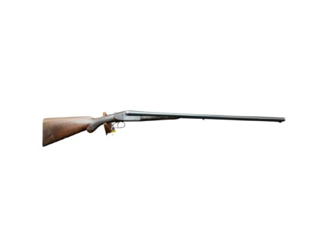 Side view of a wooden-stock rifle with a long metal barrel on a white background.
