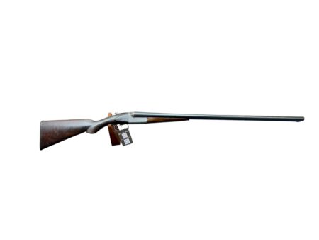 Long-barrel rifle with a wooden stock lying horizontally on a white background