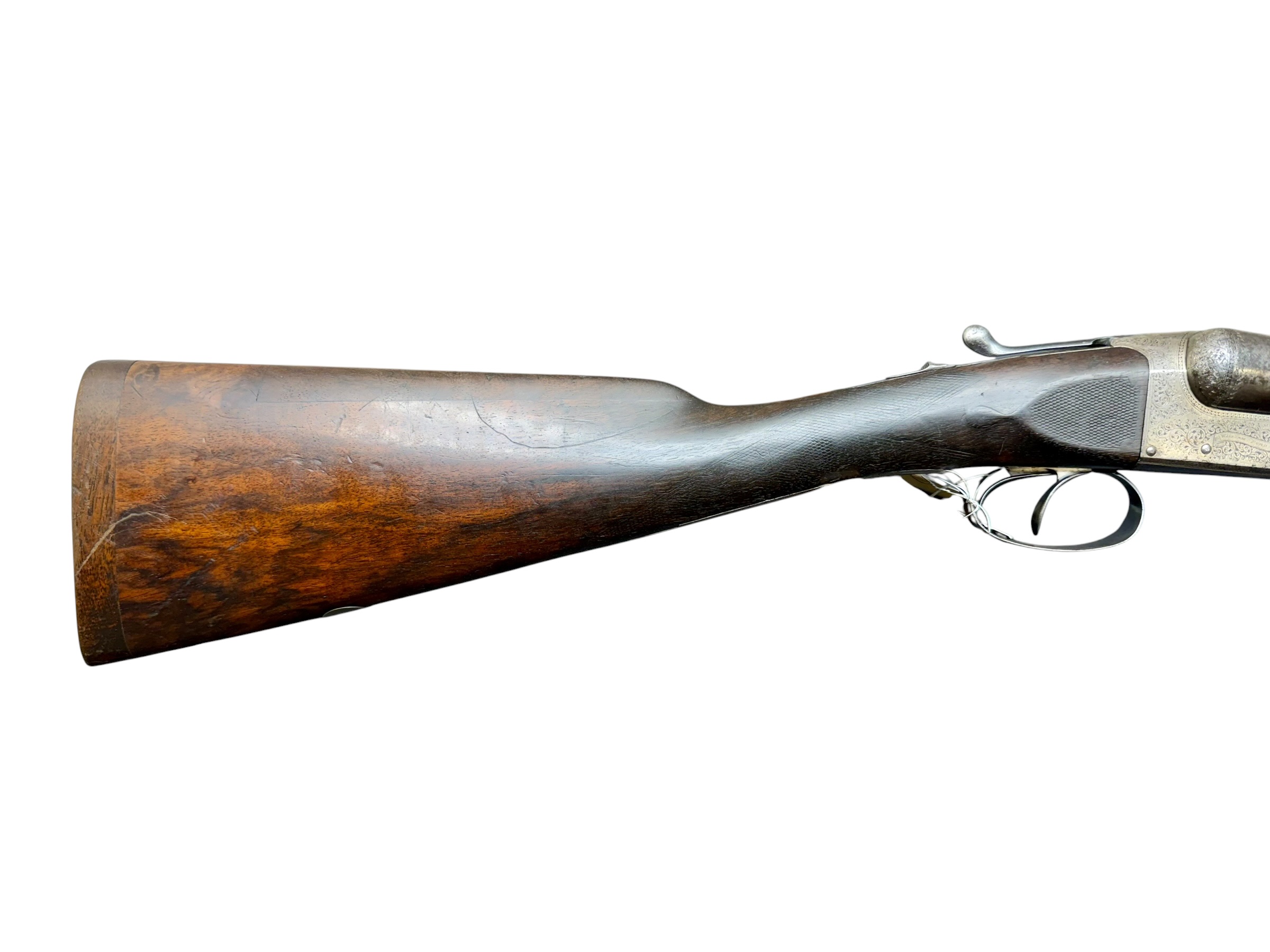 IMG_5307-Photoroom - OWS-Ammo Partial view of a wooden-stocked rifle with a metal trigger guard and ornate engravings on the receiver