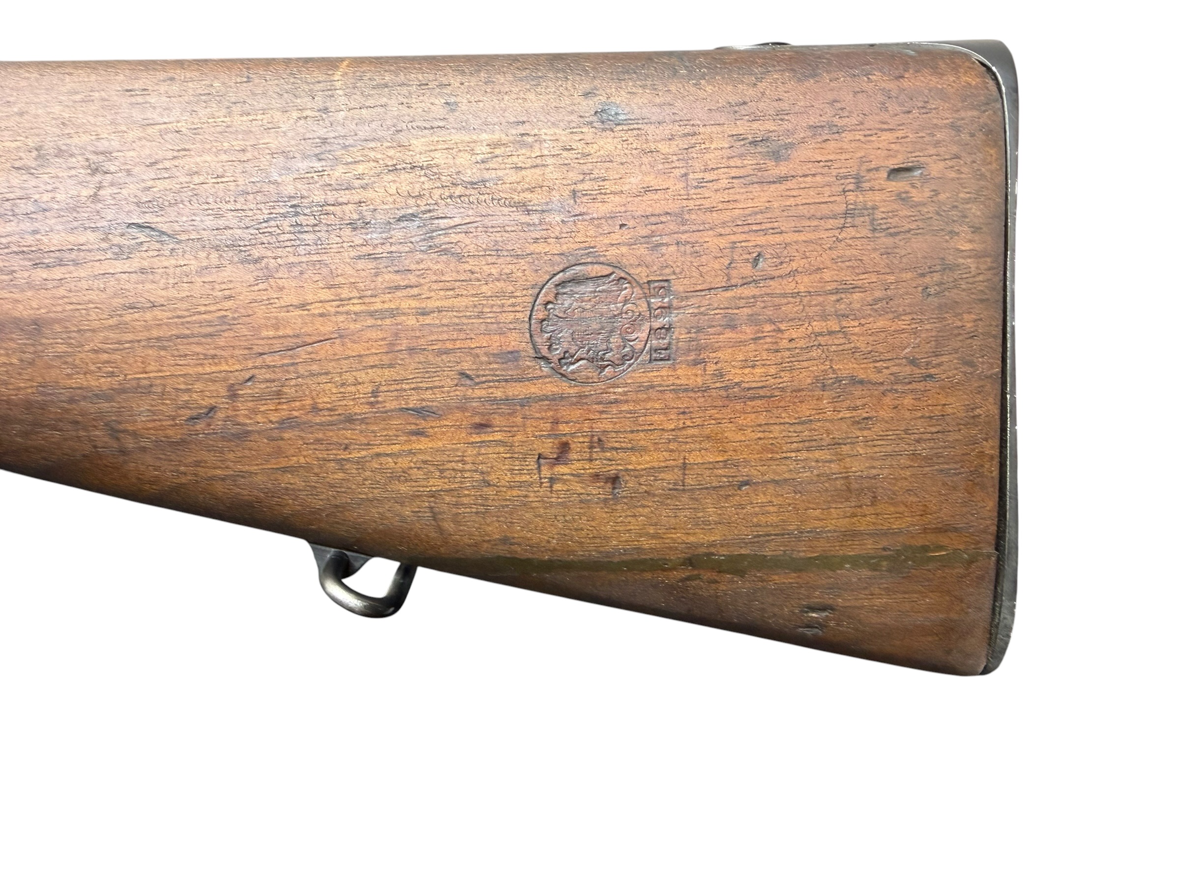 IMG_5328-Photoroom - OWS-Ammo Close-up of a worn wooden rifle stock with a circular maker's mark and a metal sling swivel.
