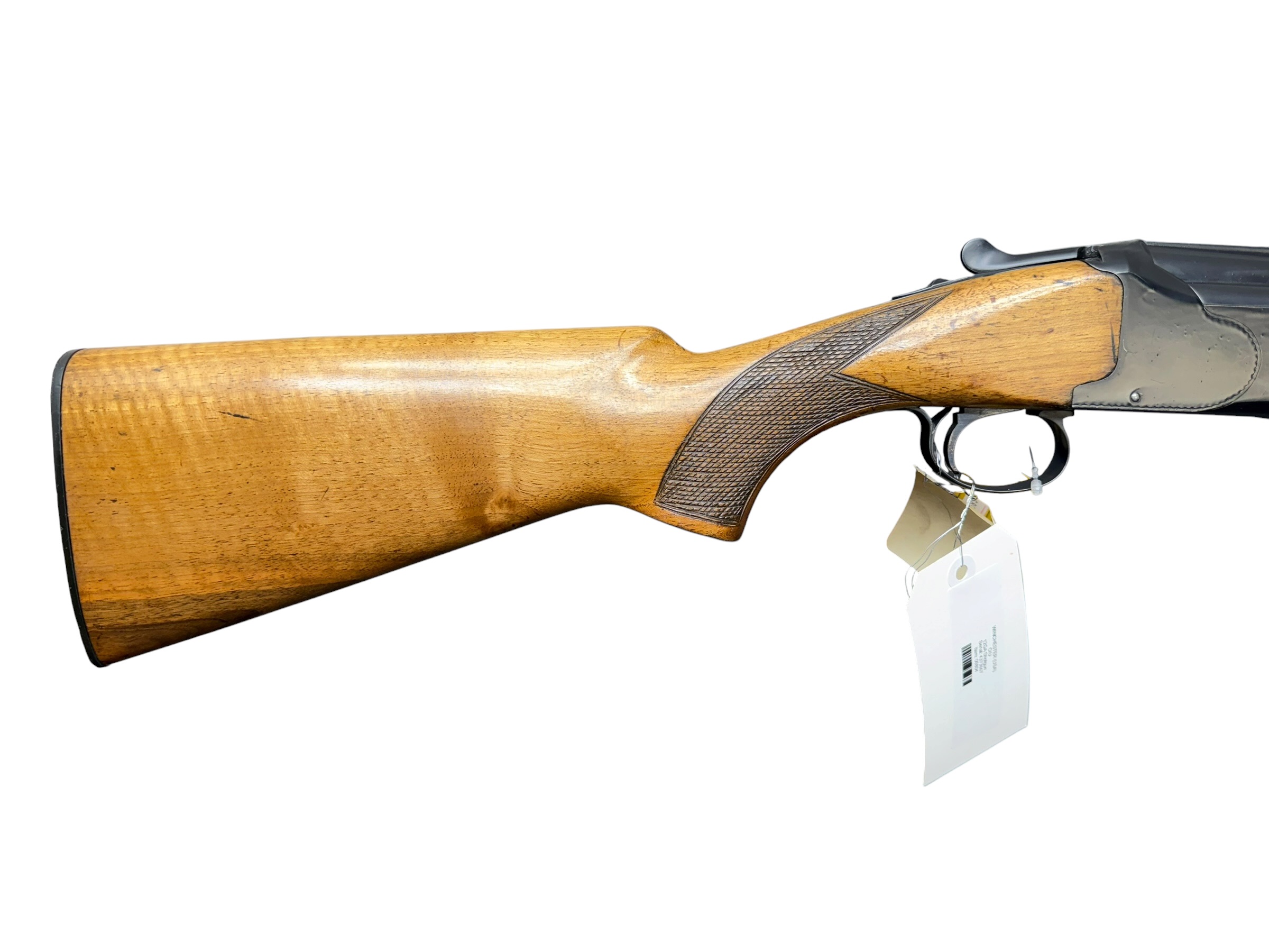 IMG_5366-Photoroom - OWS-Ammo Side view of a wooden shotgun stock with checkered grip and metal receiver, with price tags hanging from the trigger area against a white background