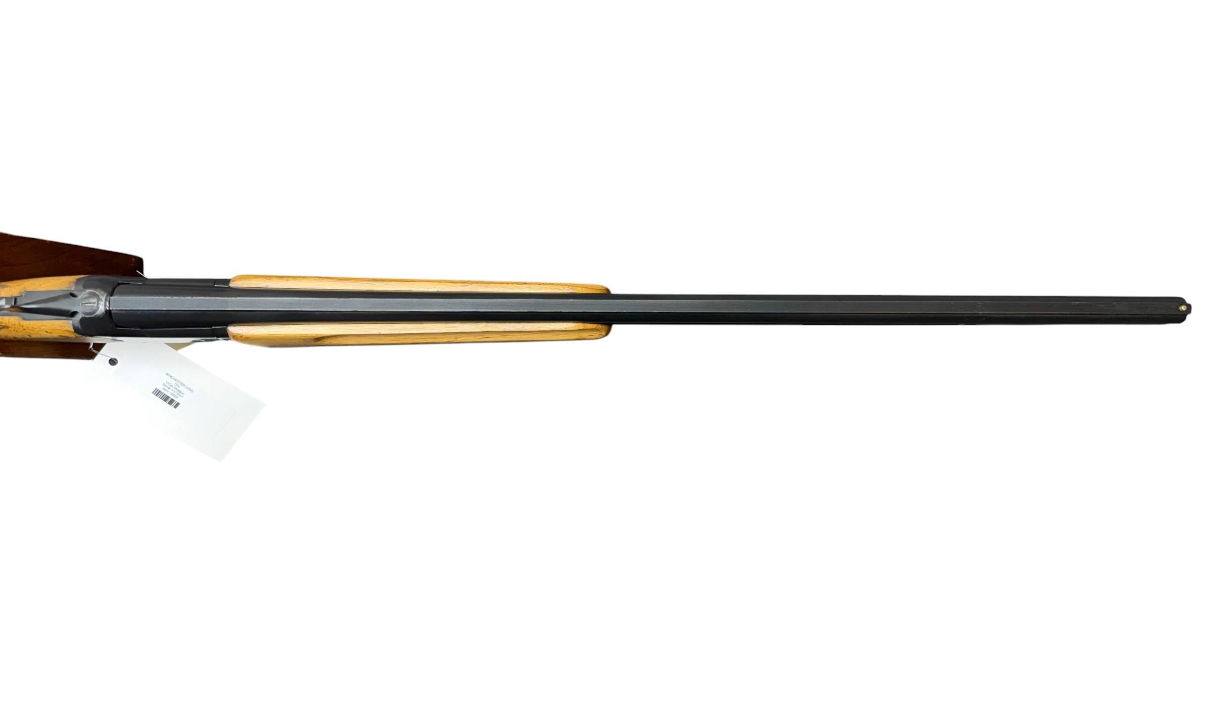 IMG_5370-Photoroom - OWS-Ammo Side view of a long-barrel shotgun with a wooden stock and fore-end, a white price tag hanging from the trigger area.