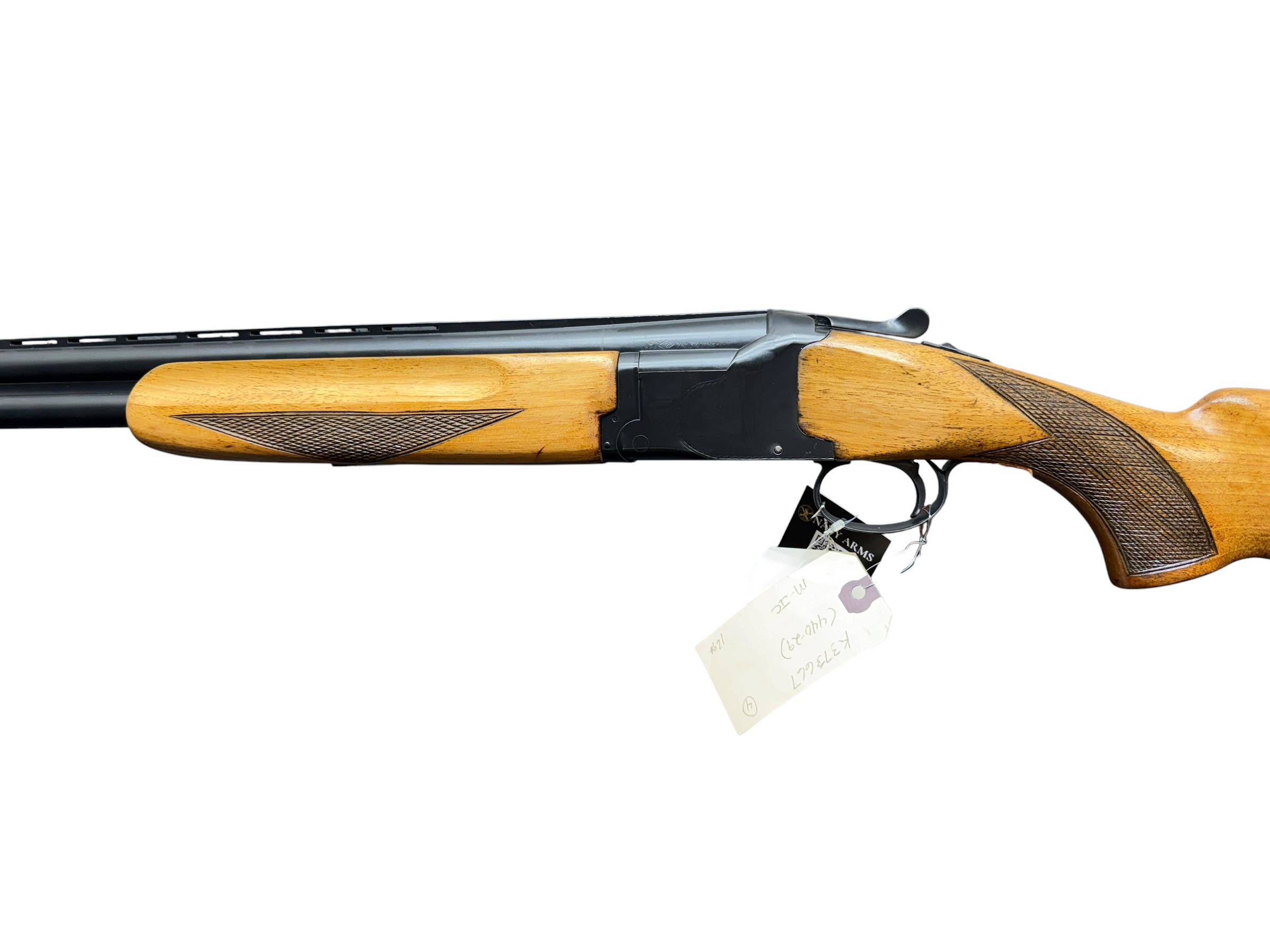 IMG_5373-Photoroom - OWS-Ammo Side view of a wooden-stock rifle with a metal barrel and a tag hanging from the trigger guard, photographed in profile.