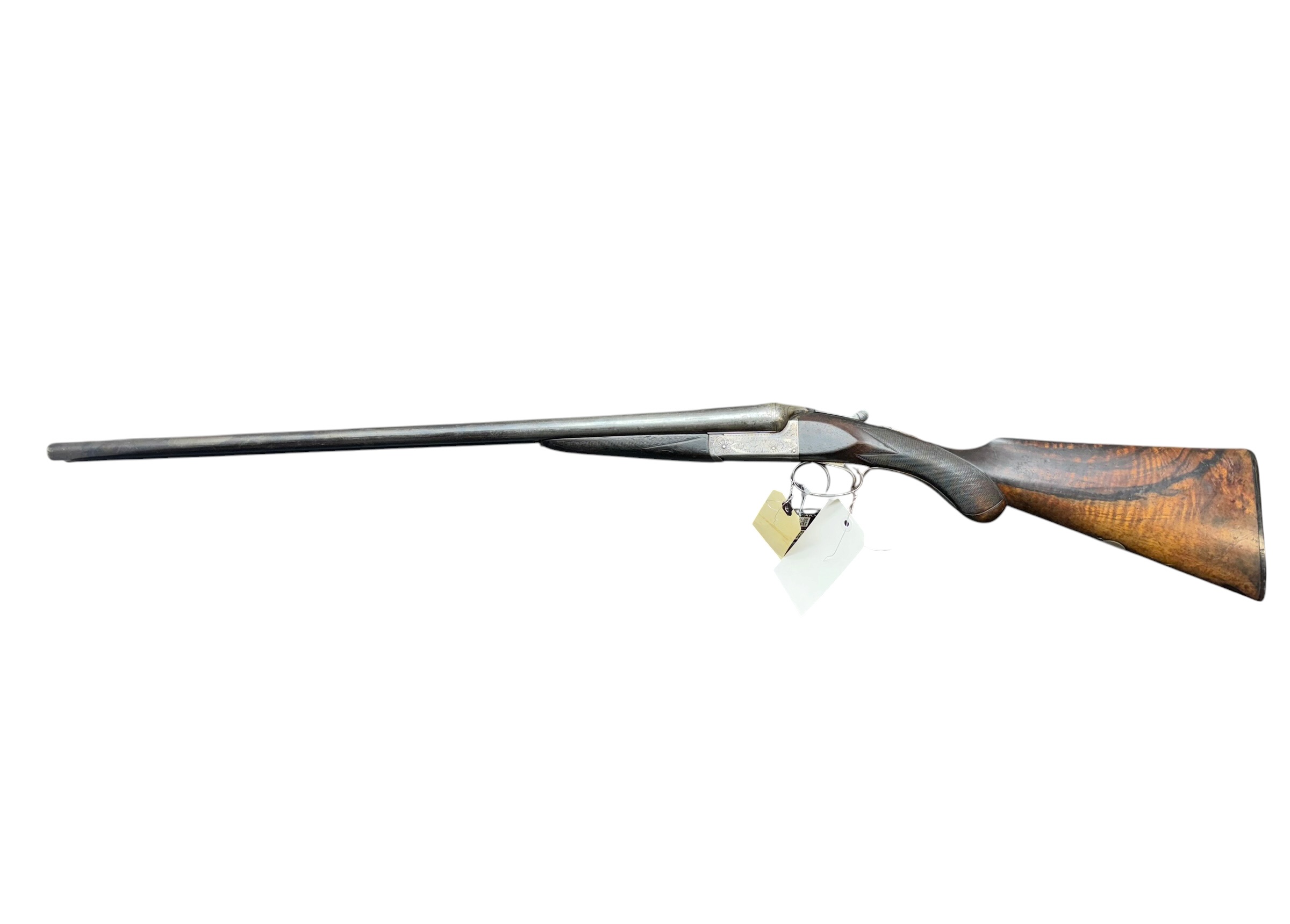 IMG_5387-Photoroom - OWS-Ammo Side view of a long-barrel shotgun with a wooden stock and metal receiver, lying horizontally to the right of the frame.