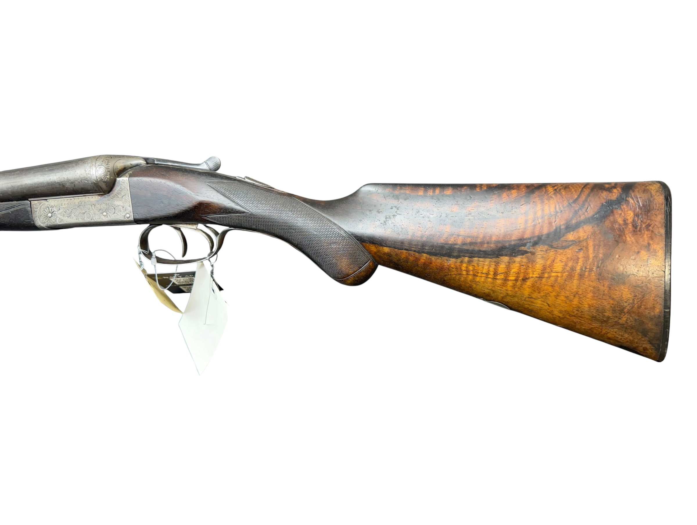 IMG_5388-Photoroom - OWS-Ammo Antique rifle shown in side view with a carved wooden stock and ornate metal receiver and trigger guard.