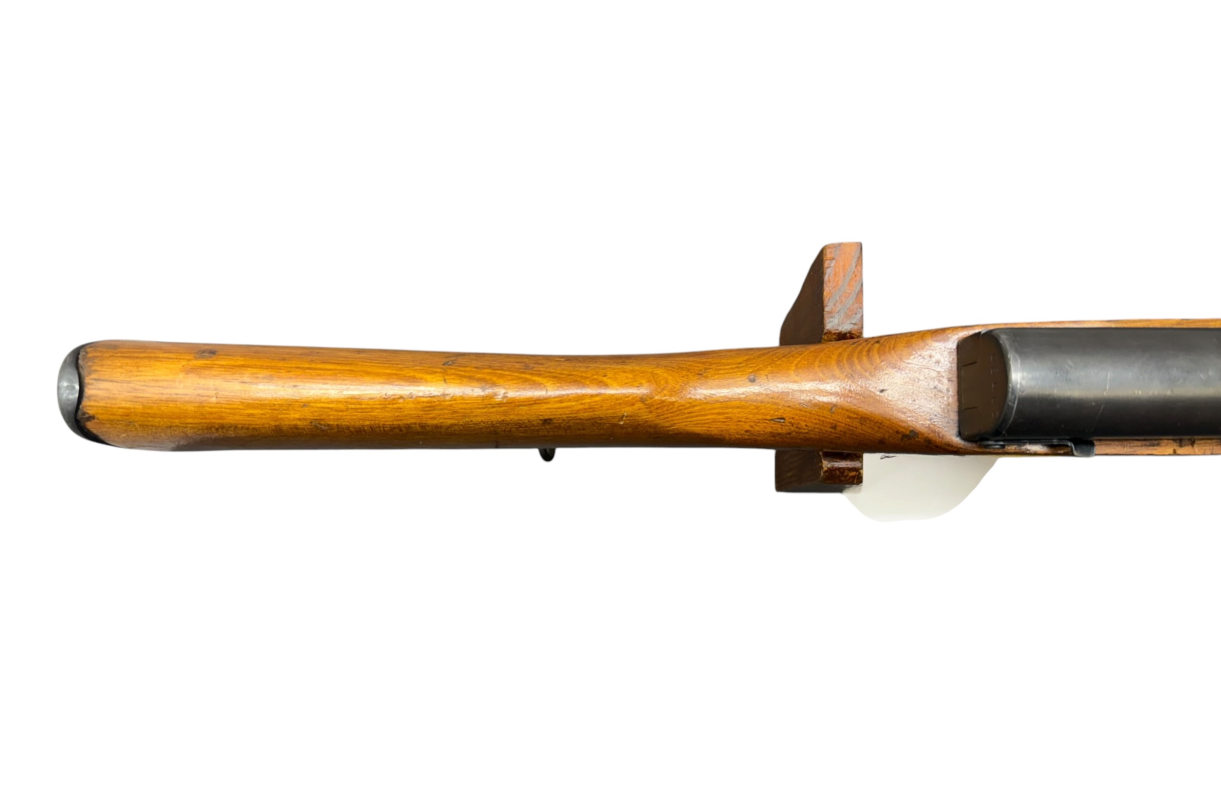 Side view of a wooden rifle stock and metal barrel on a white background.