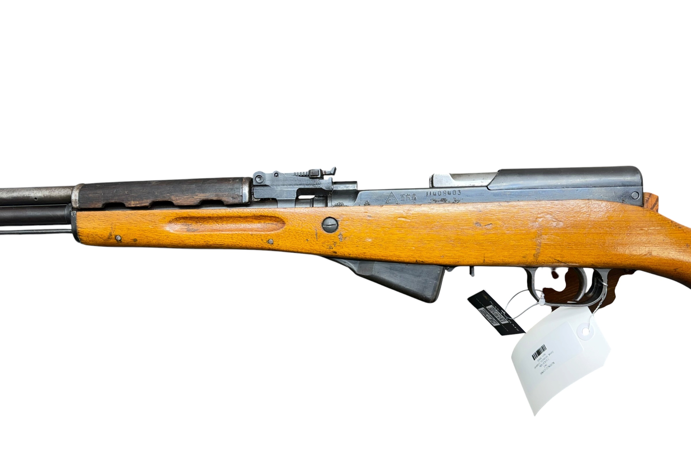 Side view of a wooden-stocked rifle with a metal receiver, shown horizontally with a price tag attached to the stock against a white background.