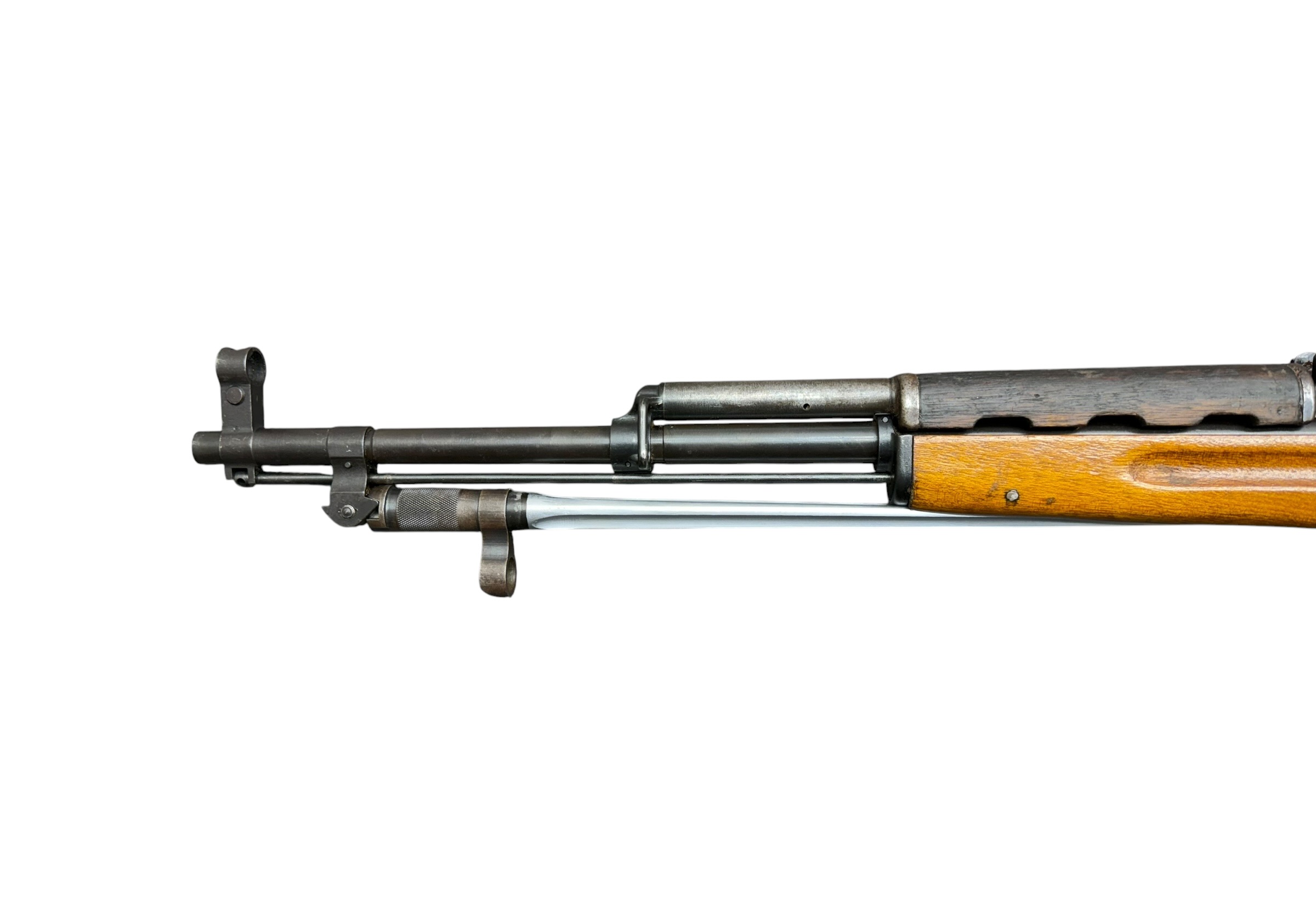 Close-up of a vintage bolt-action rifle showing the metal barrel, receiver, and wooden stock from the side.