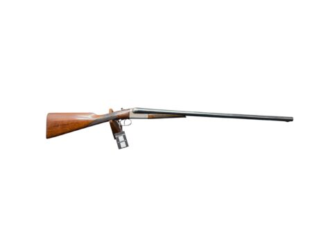 Bolt-action rifle with a polished wooden stock and long metal barrel, displayed horizontally with a tag attached.