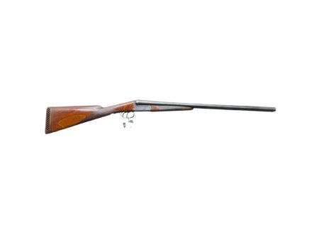 Side view of a hunting shotgun with a wooden stock and long barrel on a white background
